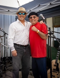 photo of Leonard and Paul Solano standing next to each other on stage